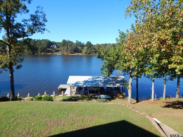 dock area featuring a yard and a water view