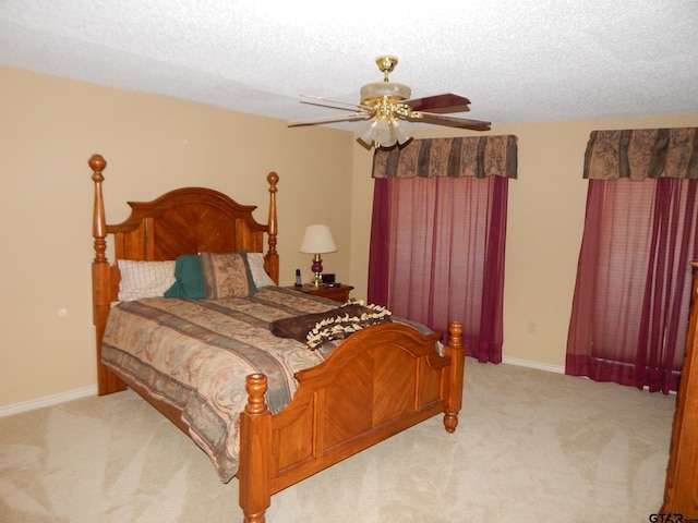 3073 E Lake Lake, Gladewater, TX 75647 - bedroom featuring light carpet, a ceiling fan, baseboards, and a textured ceiling