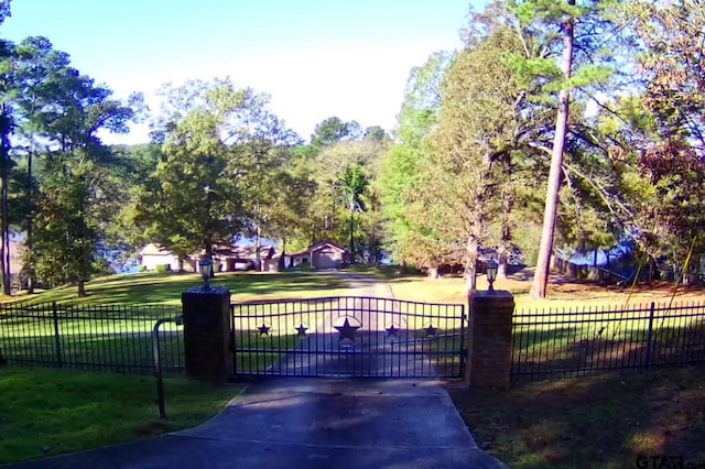 view of gate featuring a yard