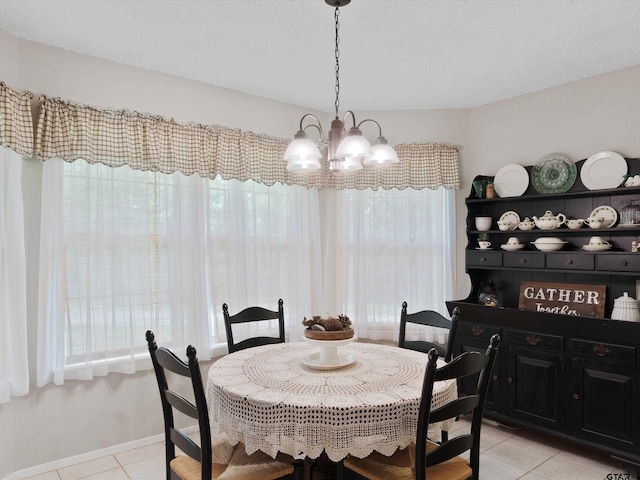 184 Shiprock Path, Holly Lake Ranch, TX 75765 - dining area with light tile patterned floors and a chandelier