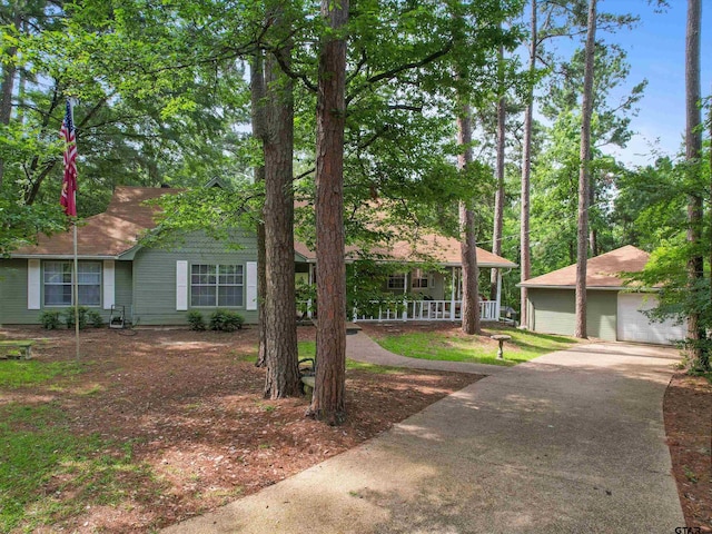 184 Shiprock Path, Holly Lake Ranch, TX 75765 - view of front of property with an outbuilding, covered porch, and a detached garage