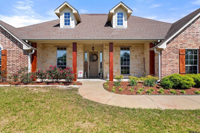 16050 Stonebriar Ct, Lindale, TX 75771 - view of front facade featuring stone siding, a front lawn, roof with shingles, and brick siding
