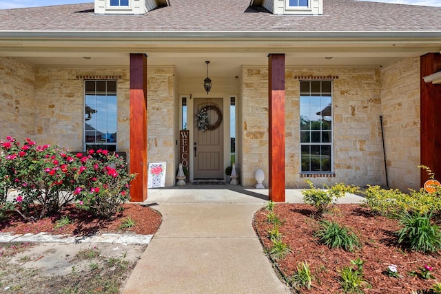 16050 Stonebriar Ct, Lindale, TX 75771 - entrance to property with roof with shingles, stone siding, and a porch