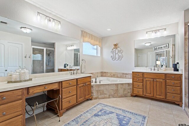 16050 Stonebriar Ct, Lindale, TX 75771 - bathroom with two vanities, tile patterned floors, a stall shower, and a bath