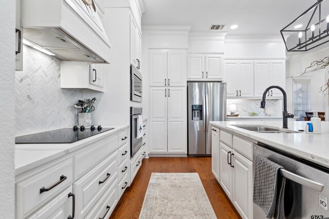 16050 Stonebriar Ct, Lindale, TX 75771 - kitchen with stainless steel appliances, premium range hood, decorative backsplash, ornamental molding, and recessed lighting