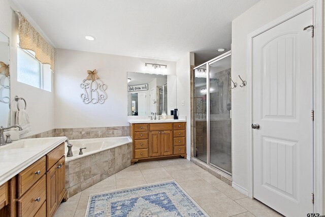 16050 Stonebriar Ct, Lindale, TX 75771 - bathroom featuring two vanities, tile patterned flooring, a stall shower, and a garden tub