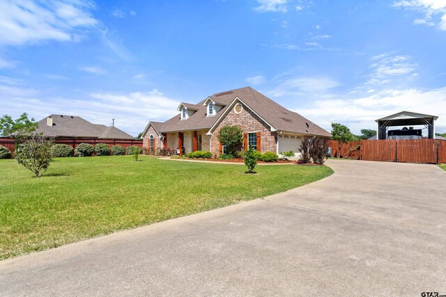 16050 Stonebriar Ct, Lindale, TX 75771 - view of front of property featuring brick siding, driveway, a carport, and a garage