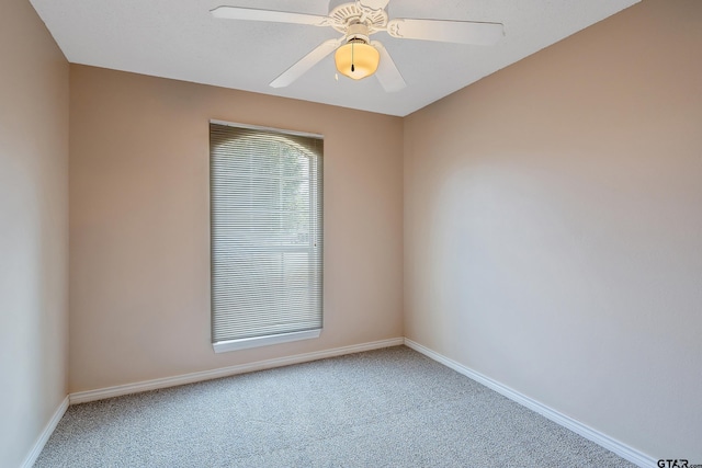 spare room featuring carpet and ceiling fan