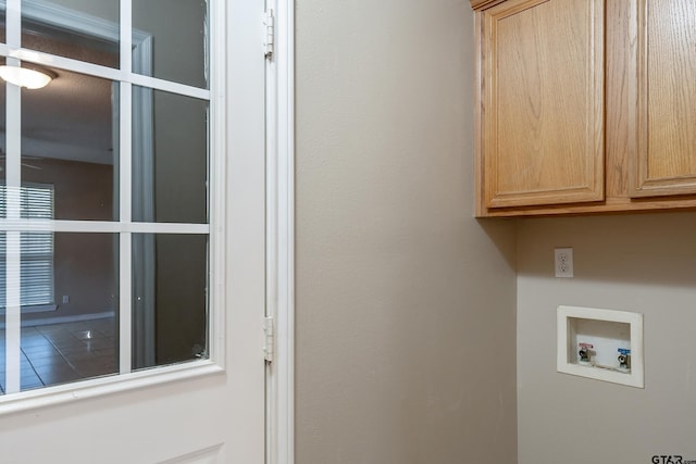 laundry area with hookup for a washing machine and cabinets