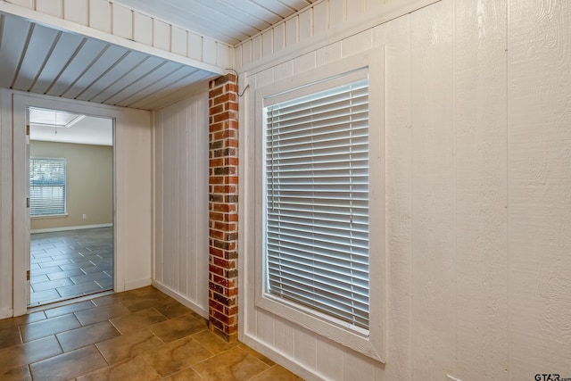 interior details with wooden walls and tile patterned flooring