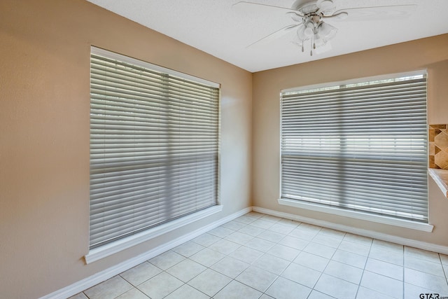 tiled empty room with ceiling fan