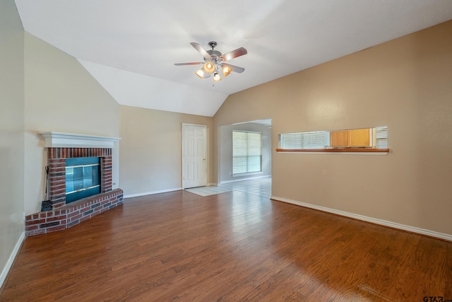 unfurnished living room with a brick fireplace, ceiling fan, wood-type flooring, and lofted ceiling