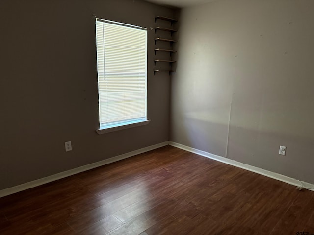 empty room with dark wood-type flooring