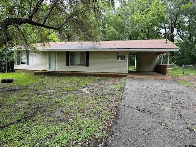 ranch-style home featuring a carport