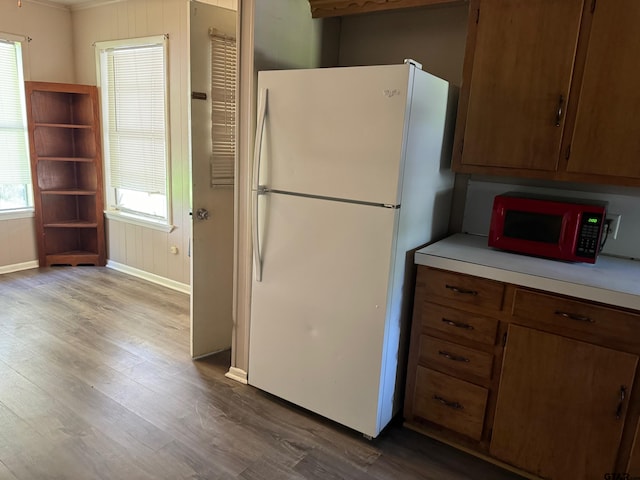 kitchen featuring wood-type flooring and white fridge