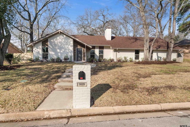 ranch-style house featuring a front lawn