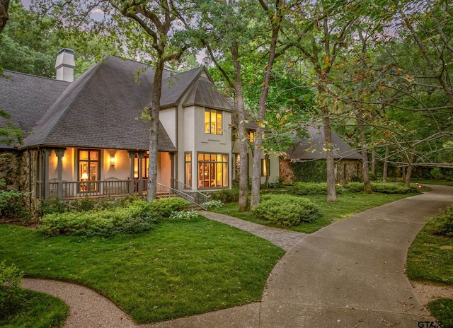 tudor house featuring a front lawn and a gazebo