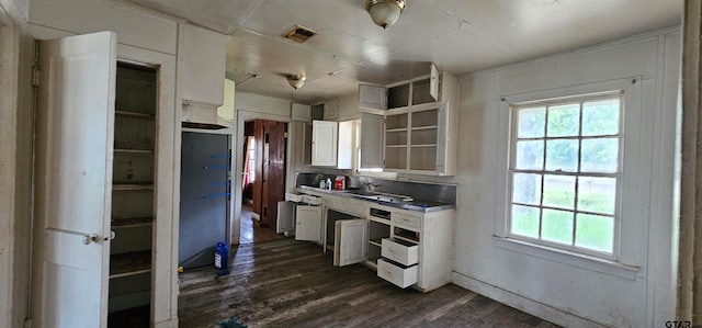 kitchen featuring white cabinetry and dark hardwood / wood-style flooring