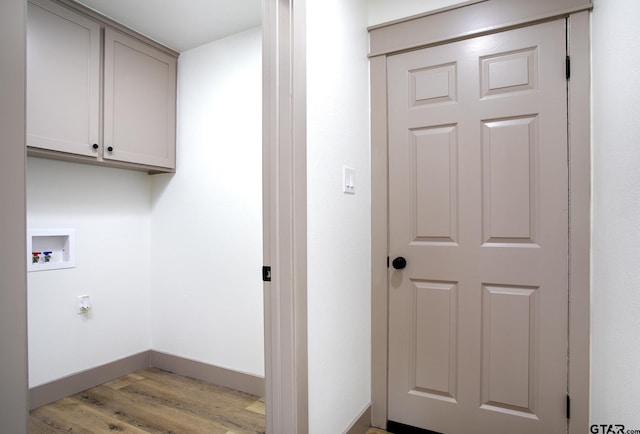 411 W Heritage Dr, Tyler, TX 75703 - laundry area with hookup for a washing machine, cabinet space, light wood-type flooring, and baseboards
