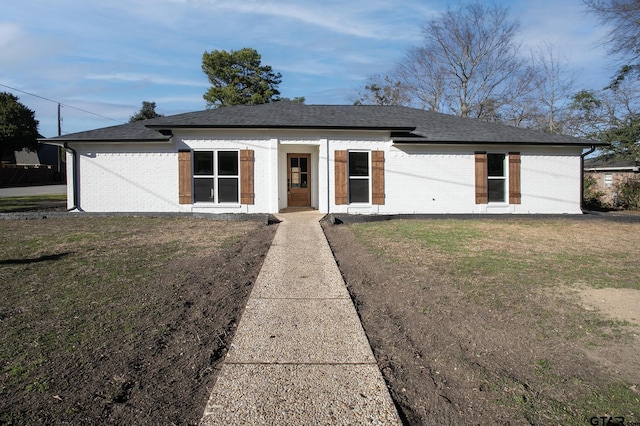 411 W Heritage Dr, Tyler, TX 75703 - view of front of property featuring brick siding, a front yard, and a shingled roof