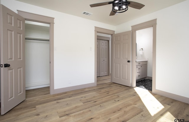 411 W Heritage Dr, Tyler, TX 75703 - unfurnished bedroom with light wood-style floors, a closet, baseboards, and connected bathroom