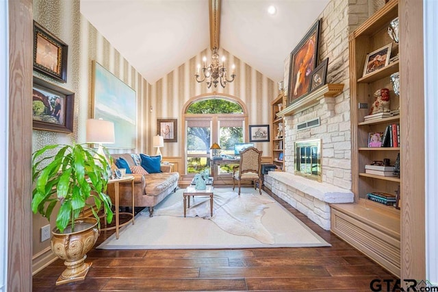 273 Fm 2276, Kilgore, TX 75662 - sitting room with wood-type flooring, an inviting chandelier, a fireplace, wallpapered walls, and lofted ceiling with beams