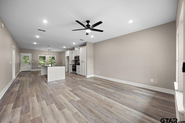 437 Tara Ln, Troup, TX 75789 - unfurnished living room featuring recessed lighting, light wood-style flooring, and a ceiling fan