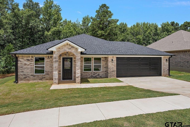 437 Tara Ln, Troup, TX 75789 - view of front of home featuring a garage, driveway, a front yard, and brick siding