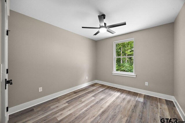 437 Tara Ln, Troup, TX 75789 - spare room featuring a ceiling fan and wood finished floors