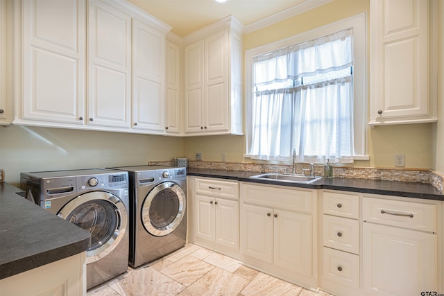 clothes washing area featuring sink, cabinets, a healthy amount of sunlight, separate washer and dryer, and ornamental molding