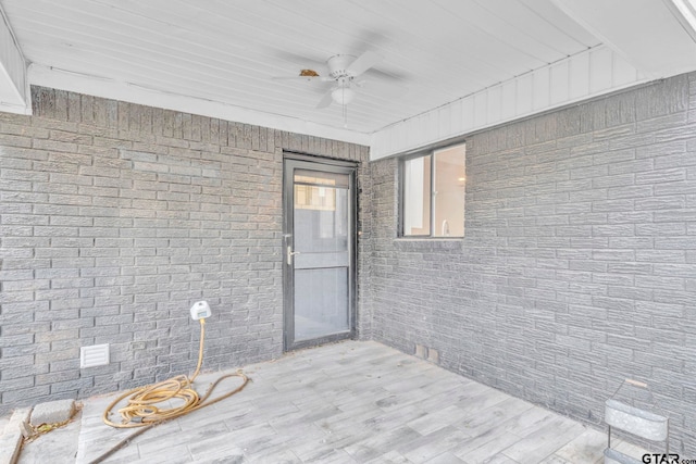 interior space with ceiling fan