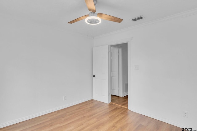 spare room with crown molding, ceiling fan, and light wood-type flooring