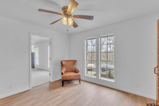 sitting room featuring ceiling fan and light hardwood / wood-style floors