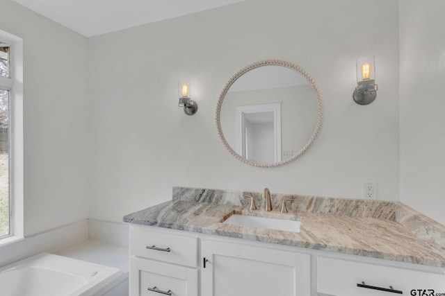 bathroom with vanity and a tub to relax in