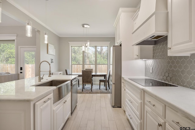 kitchen with white cabinets, decorative light fixtures, stainless steel appliances, and custom exhaust hood