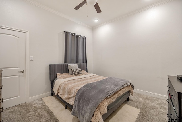 carpeted bedroom featuring ceiling fan and crown molding