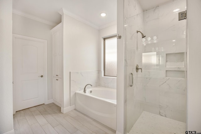 bathroom featuring separate shower and tub and crown molding