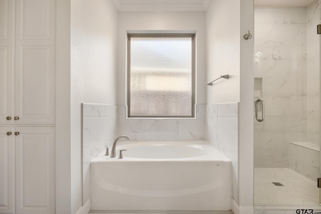 bathroom featuring crown molding and independent shower and bath