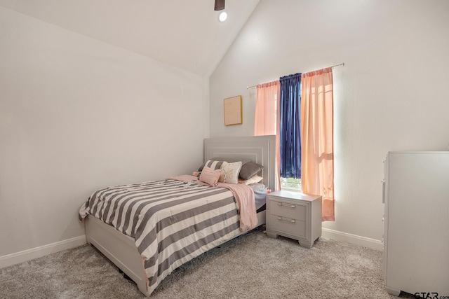 bedroom with high vaulted ceiling and light colored carpet