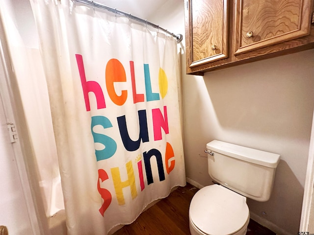 bathroom with walk in shower, hardwood / wood-style flooring, and toilet