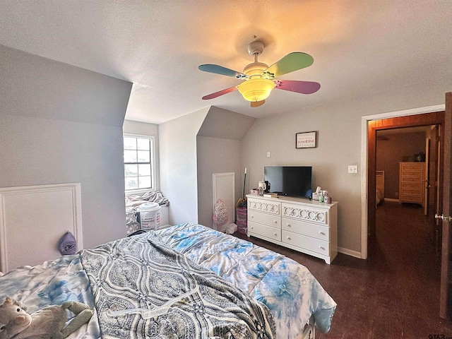 carpeted bedroom featuring ceiling fan, a textured ceiling, and vaulted ceiling