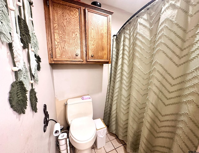 bathroom with toilet, tile patterned flooring, and curtained shower