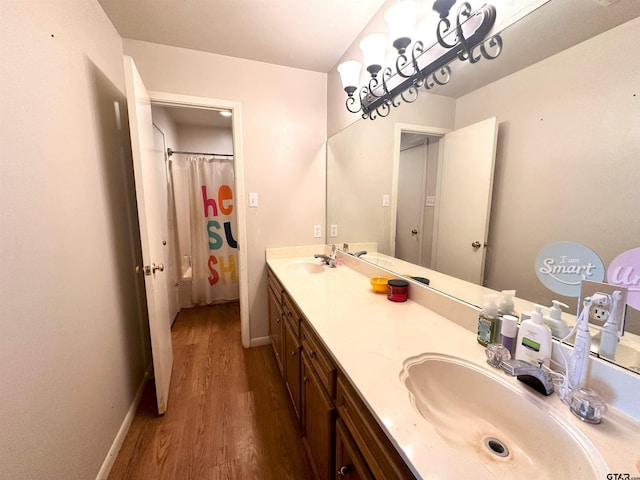 bathroom with hardwood / wood-style floors and vanity