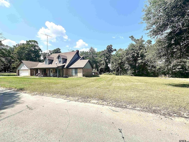 view of front facade with a front yard and a garage