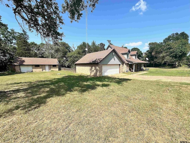 view of side of home featuring a garage and a yard