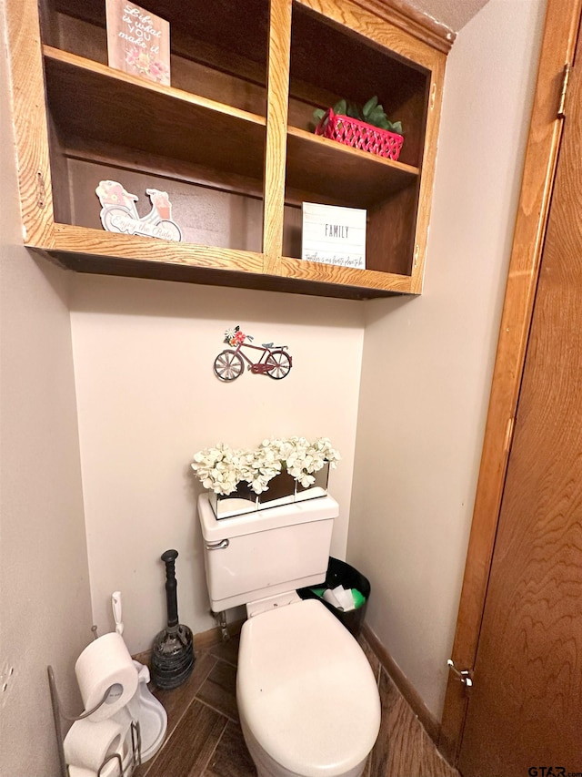 bathroom with hardwood / wood-style floors and toilet