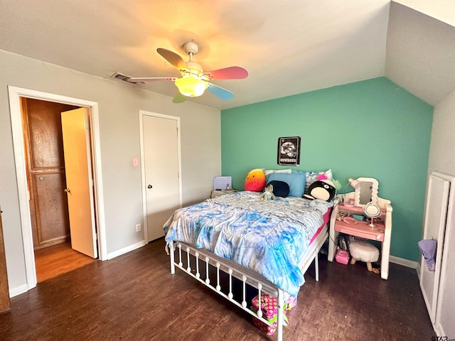 bedroom with dark hardwood / wood-style flooring, vaulted ceiling, and ceiling fan