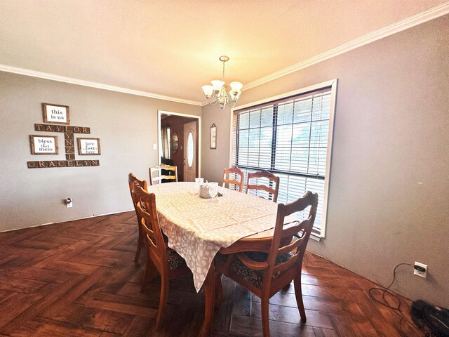 dining room featuring ornamental molding, dark parquet flooring, and a chandelier