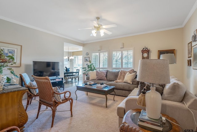 living room featuring crown molding, ceiling fan with notable chandelier, and light colored carpet