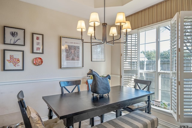 dining space featuring plenty of natural light and an inviting chandelier